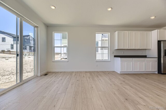 39867 Floyd St, Elizabeth, CO 80107 - unfurnished living room with light wood-type flooring, plenty of natural light, baseboards, and recessed lighting