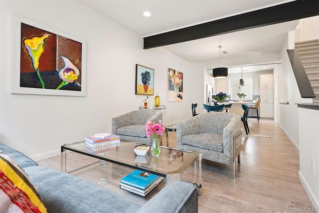 living room with beam ceiling, baseboards, light wood-style flooring, and recessed lighting