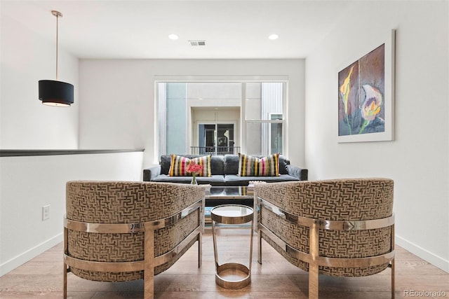 sitting room featuring wood finished floors, visible vents, baseboards, and recessed lighting