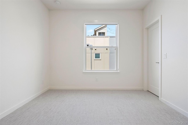 empty room with carpet floors and baseboards