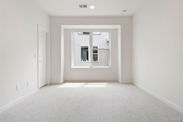 carpeted empty room featuring baseboards, recessed lighting, and visible vents