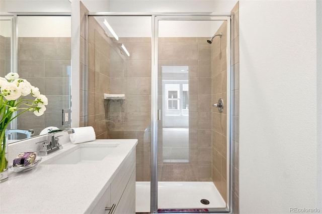 bathroom featuring a stall shower and vanity