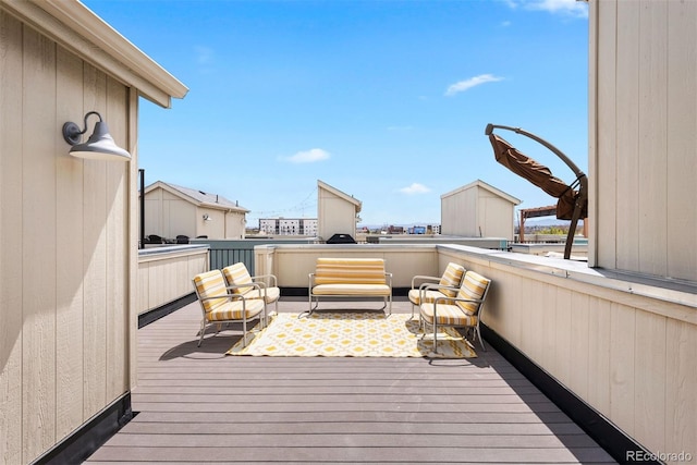 wooden terrace featuring an outdoor living space