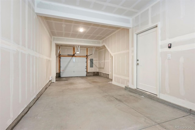 interior space with concrete floors and electric panel
