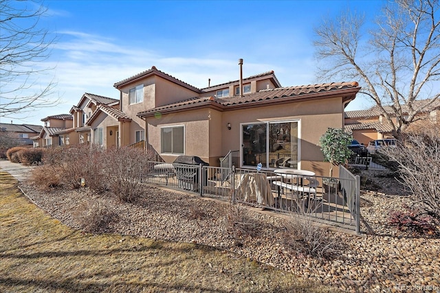 back of property with a patio