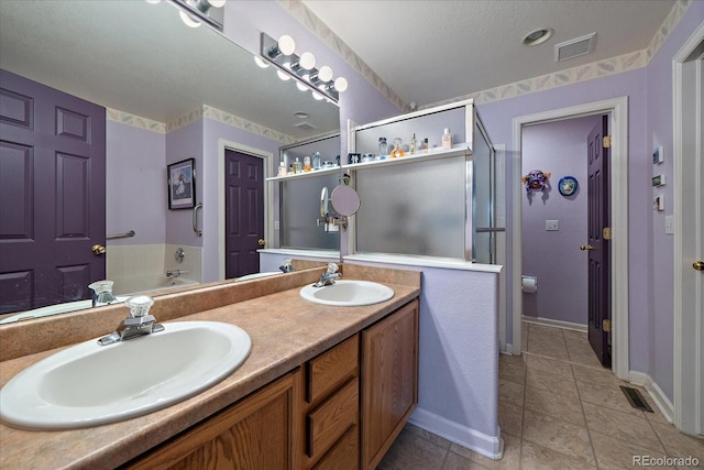 bathroom featuring vanity, tile patterned floors, and a bathtub