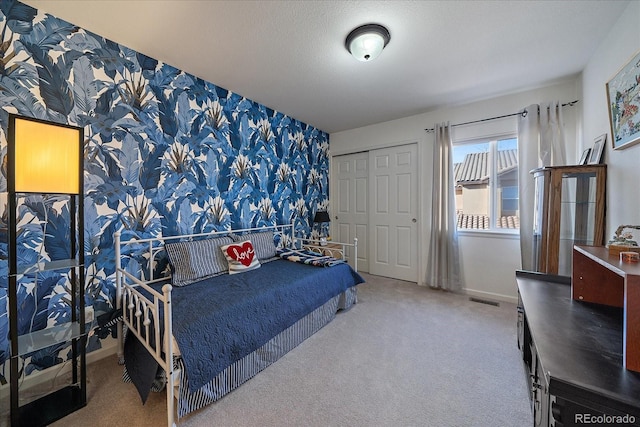 bedroom with a textured ceiling and carpet