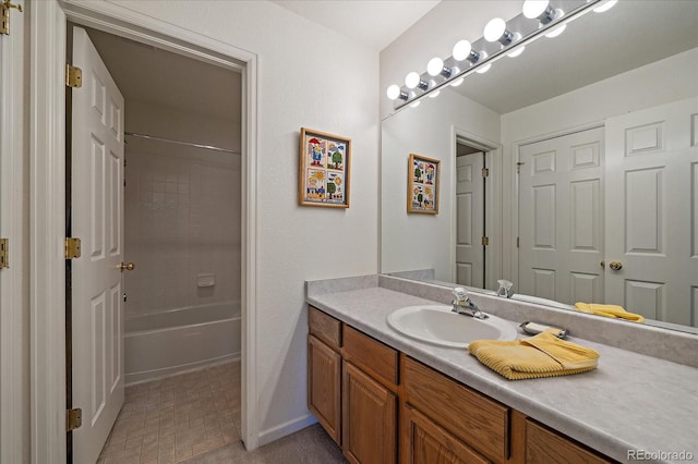 bathroom with tiled shower / bath combo and vanity