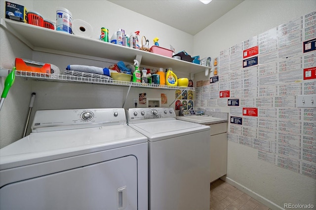 laundry room with cabinets and separate washer and dryer