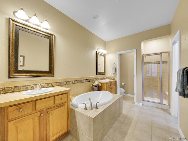 9246 Sori Ln, Highlands Ranch, CO 80126 - bathroom featuring toilet, a shower stall, two vanities, a garden tub, and tile patterned floors
