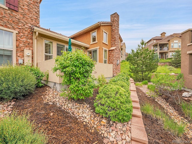 9246 Sori Ln, Highlands Ranch, CO 80126 - view of side of property featuring stucco siding and stone siding