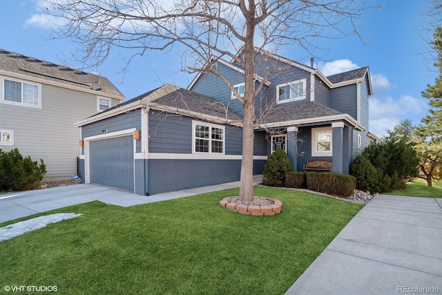 view of front property featuring a garage and a front yard