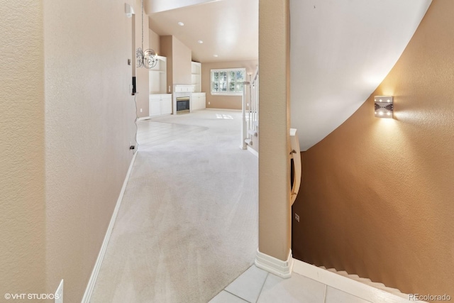 staircase with tile patterned floors and a tiled fireplace