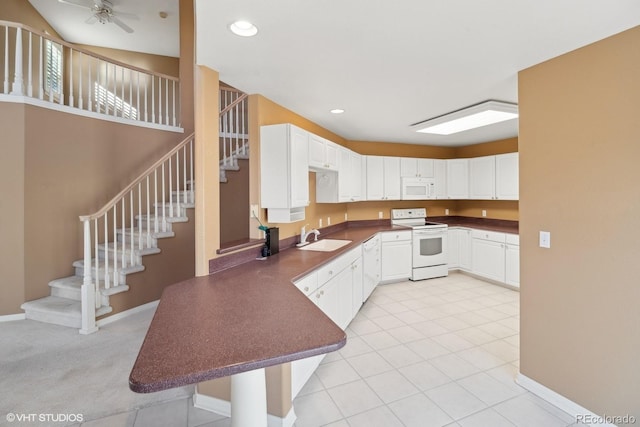 kitchen with sink, white appliances, light tile patterned floors, ceiling fan, and white cabinetry