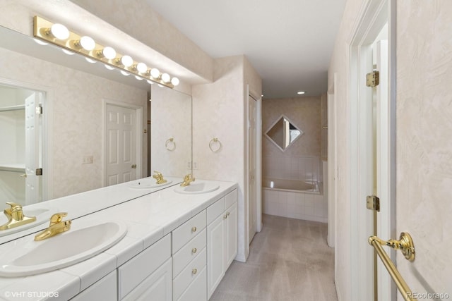 bathroom featuring vanity and a relaxing tiled tub