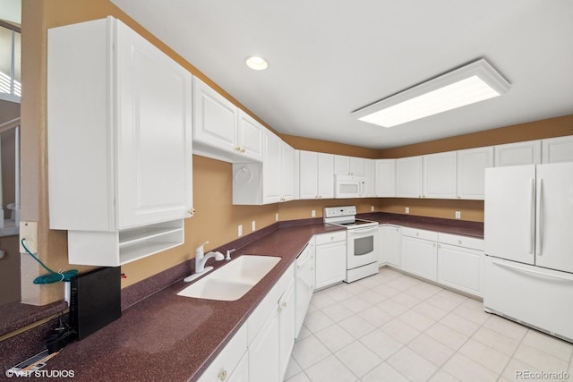 kitchen featuring white cabinetry, sink, light tile patterned flooring, and white appliances