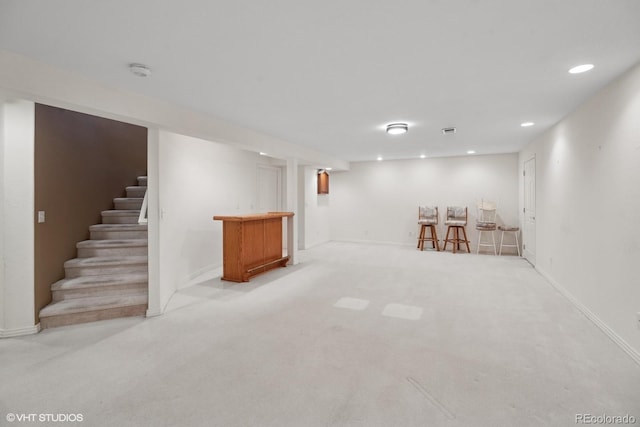 basement with light colored carpet and bar area