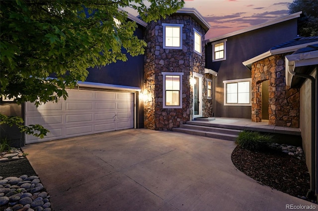 2832 Danbury Ave, Highlands Ranch, CO 80126 - view of front facade featuring stone siding, concrete driveway, stucco siding, and a garage