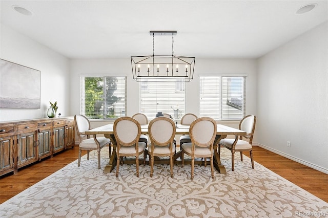 2832 Danbury Ave, Highlands Ranch, CO 80126 - dining room featuring wood finished floors, a chandelier, and baseboards