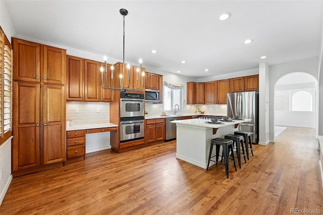 2832 Danbury Ave, Highlands Ranch, CO 80126 - kitchen with appliances with stainless steel finishes, brown cabinets, backsplash, and recessed lighting