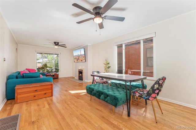511 S Pennsylvania St, Denver, CO 80209 - living area with wood finished floors, a fireplace with flush hearth, a ceiling fan, and ornamental molding