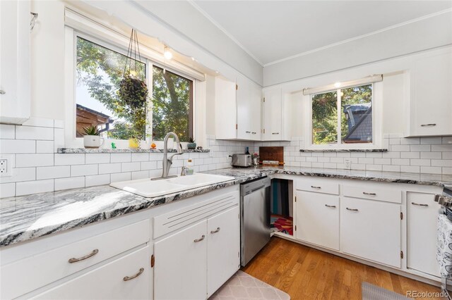 511 S Pennsylvania St, Denver, CO 80209 - kitchen featuring a sink, dishwasher, crown molding, healthy amount of natural light, and white cabinetry