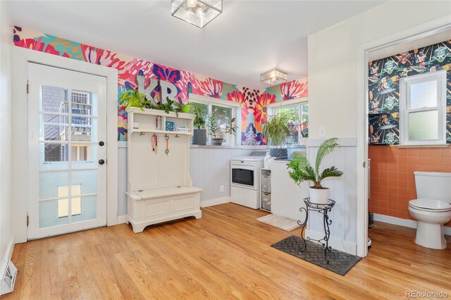 511 S Pennsylvania St, Denver, CO 80209 - entryway with separate washer and dryer, light wood-style floors, wainscoting, and tile walls