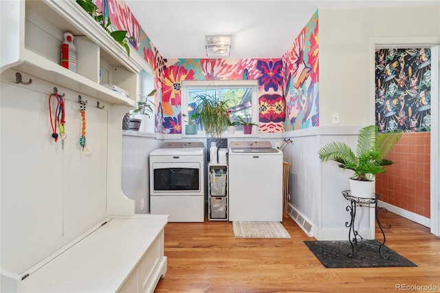 511 S Pennsylvania St, Denver, CO 80209 - washroom featuring washer and clothes dryer, light wood-style flooring, and wainscoting