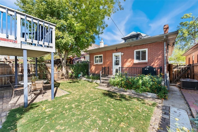 511 S Pennsylvania St, Denver, CO 80209 - rear view of house featuring a chimney, brick siding, central air condition unit, a patio area, and a wooden deck