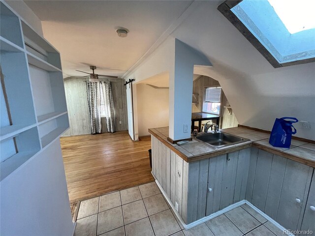 511 S Pennsylvania St, Denver, CO 80209 - corridor with a sink, a skylight, and light tile patterned floors