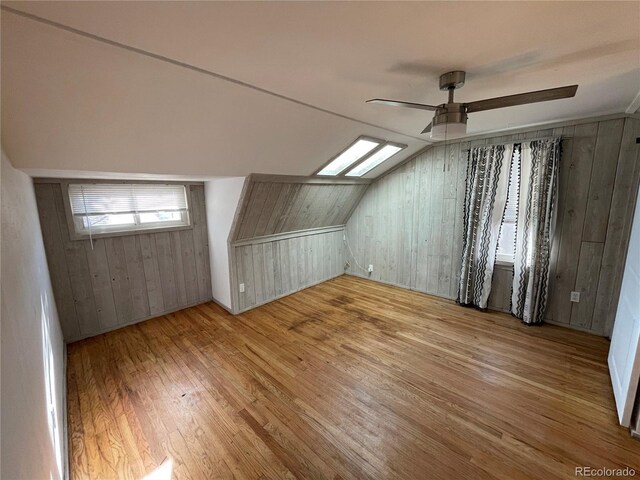 511 S Pennsylvania St, Denver, CO 80209 - bonus room with wood-type flooring, wood walls, vaulted ceiling, and a ceiling fan