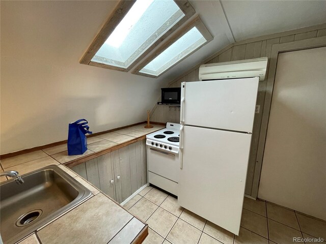 511 S Pennsylvania St, Denver, CO 80209 - kitchen with white appliances, a skylight, vaulted ceiling, a sink, and light tile patterned floors