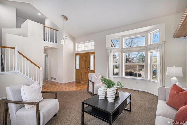 8825 Fairview Oaks Pl, Lone Tree, CO 80124 - carpeted living area with high vaulted ceiling and stairs