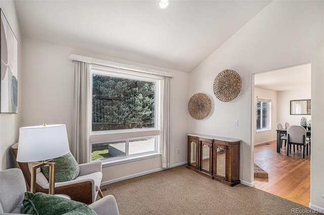 8825 Fairview Oaks Pl, Lone Tree, CO 80124 - sitting room with healthy amount of natural light, vaulted ceiling, and carpet floors