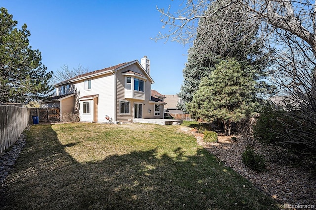 8825 Fairview Oaks Pl, Lone Tree, CO 80124 - back of house featuring a chimney, a fenced backyard, and a patio