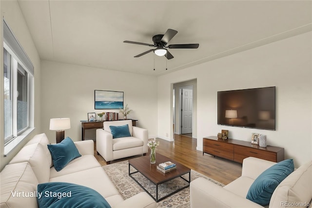 living area with ceiling fan and wood finished floors
