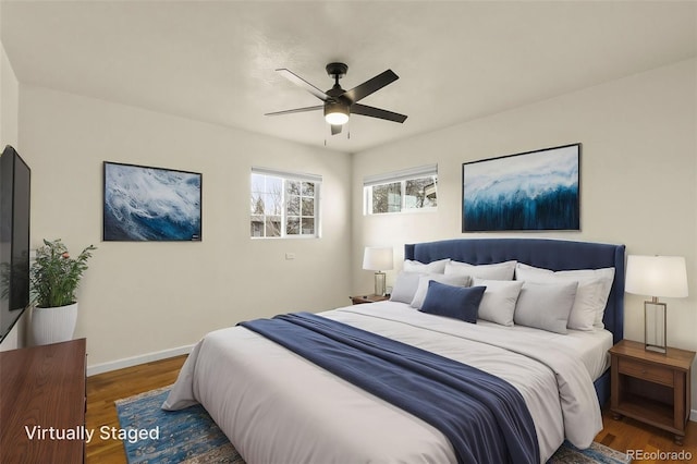 bedroom with baseboards, wood finished floors, and a ceiling fan