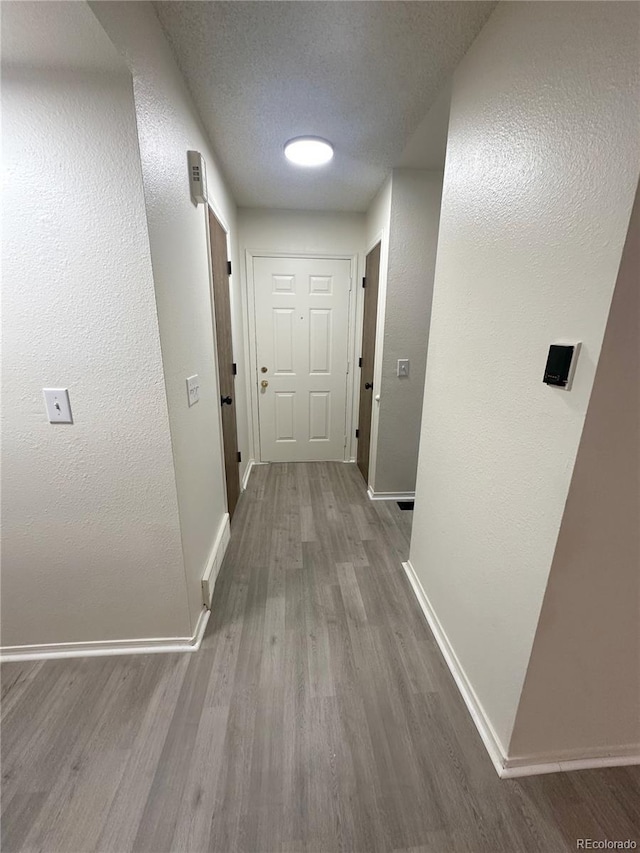 56 S Nome St, Aurora, CO 80012 - hallway with wood finished floors and a textured ceiling