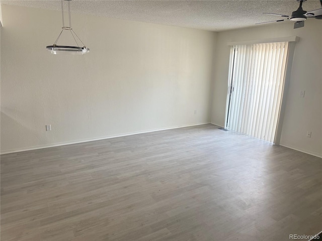 56 S Nome St, Aurora, CO 80012 - unfurnished room featuring wood finished floors, ceiling fan, and a textured ceiling