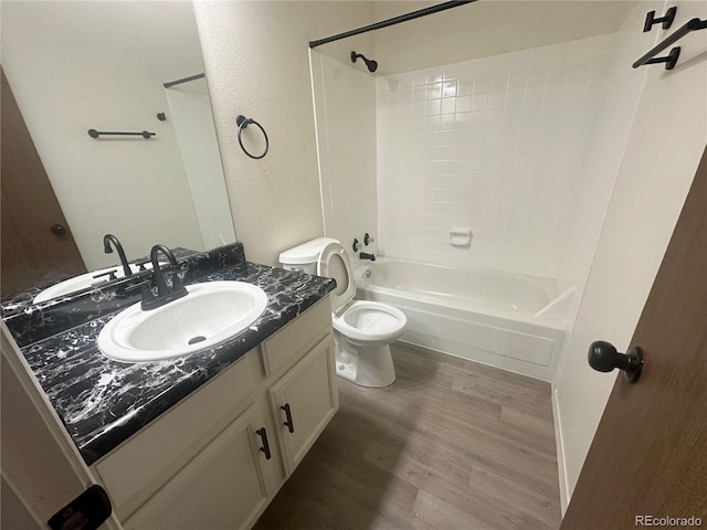 56 S Nome St, Aurora, CO 80012 - full bathroom featuring vanity, wood finished floors, and tub / shower combination