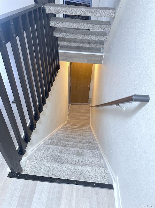 56 S Nome St, Aurora, CO 80012 - stairs with a textured wall and carpet flooring