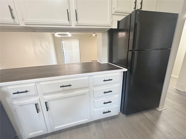 56 S Nome St, Aurora, CO 80012 - kitchen with freestanding refrigerator, white cabinetry, light wood-style flooring, and a ceiling fan