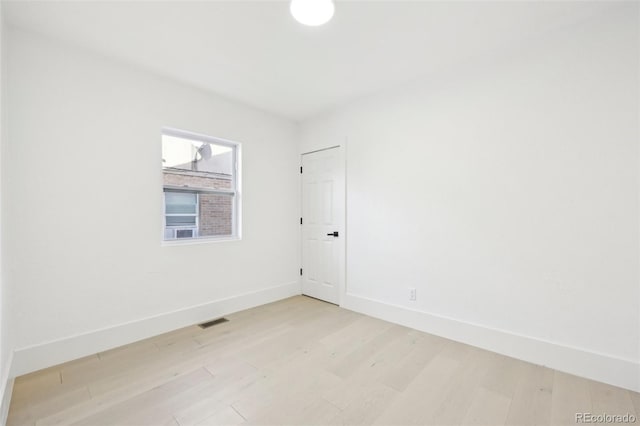 spare room featuring light wood-type flooring