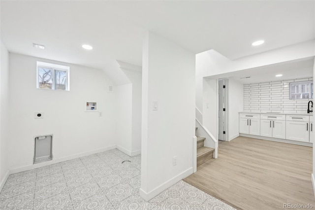 laundry room with washer hookup, light hardwood / wood-style flooring, and hookup for an electric dryer