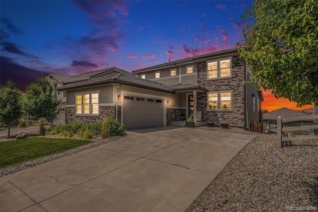3453 Pacific Peak Dr, Broomfield, CO 80023 - view of front of home featuring stone siding, a garage, and driveway