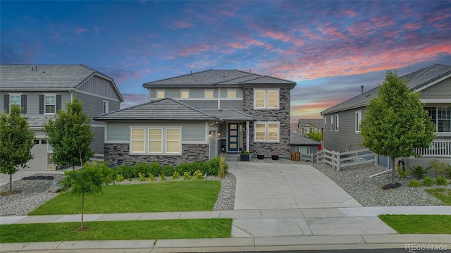 3453 Pacific Peak Dr, Broomfield, CO 80023 - view of front of property with stone siding, a front yard, and concrete driveway