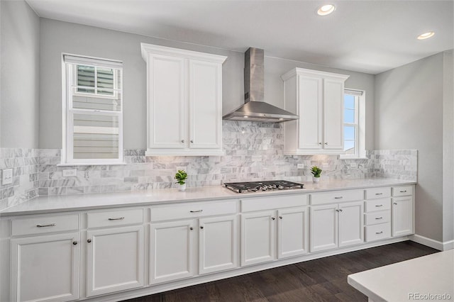 3453 Pacific Peak Dr, Broomfield, CO 80023 - kitchen featuring wall chimney range hood, stainless steel gas stovetop, white cabinets, healthy amount of natural light, and recessed lighting