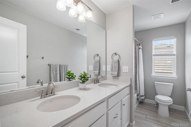 3453 Pacific Peak Dr, Broomfield, CO 80023 - full bathroom featuring double vanity, shower / bathtub combination with curtain, and wood finished floors