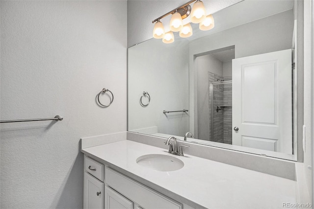3453 Pacific Peak Dr, Broomfield, CO 80023 - full bathroom featuring vanity, a shower with door, and a textured wall