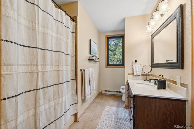 bathroom featuring vanity, a baseboard radiator, toilet, and tile patterned flooring